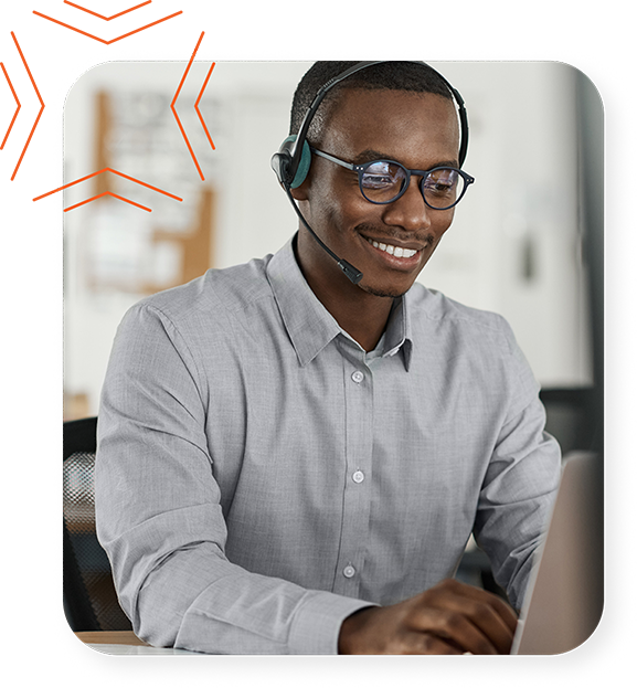Business man talking on a headset and using a laptop