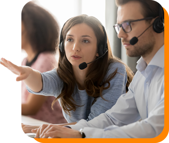 Male and female workers wearing headsets and working together