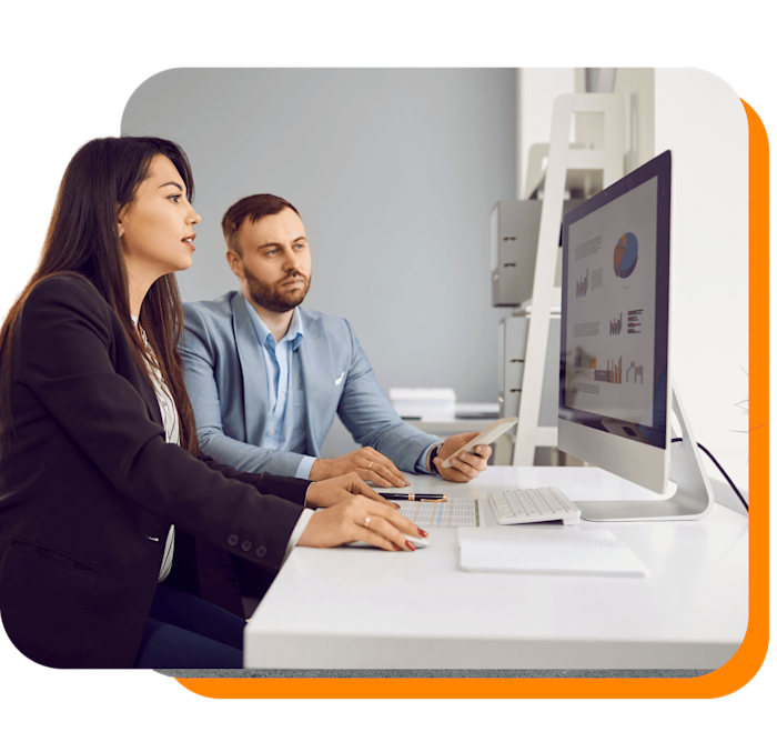 Two business people reviewing an analytics dashboard together at a computer